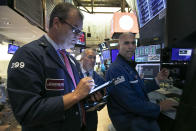 Traders William Lawrence, left, Timothy Nick, center, and specialist Philip Finale work on the floor of the New York Stock Exchange, Thursday, July 18, 2019. U.S. stocks moved lower in early trading on Wall Street Thursday after Netflix reported a slump in new subscribers and dragged down communications companies. (AP Photo/Richard Drew)