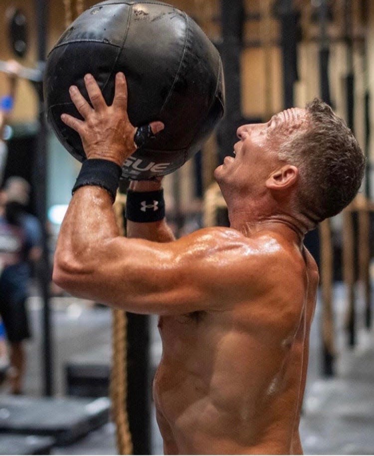 Podesto lifts up a medicine ball during one of his workouts for the upcoming 2022 CrossFit Games.