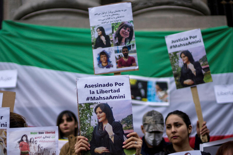 Demonstrators hold signs during a solidarity rally following the death of Iranian Mahsa Amini, who died last week in Iran after being arrested by morality police, Santiago, Chile  September 23, 2022. REUTERS/Ailen Diaz