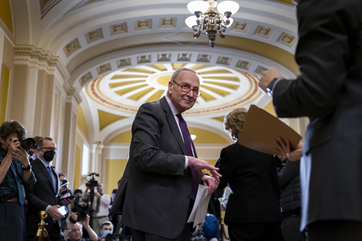 Senate Majority Leader Chuck Schumer, D-N.Y., pauses as he speaks with reporters after meeting with fellow Democrats at the Capitol in Washington, Tuesday, Dec. 13, 2022. (AP Photo/J. Scott Applewhite)