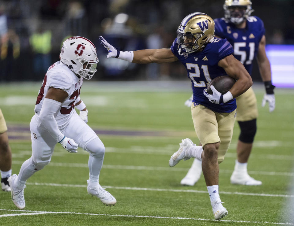 Washington Wayne Taulapapa looks to fend off Stanford defensive back Alaka'i Gilman during the first half of an NCAA college football game Saturday, Sept. 24, 2022, in Seattle. (AP Photo/Stephen Brashear)