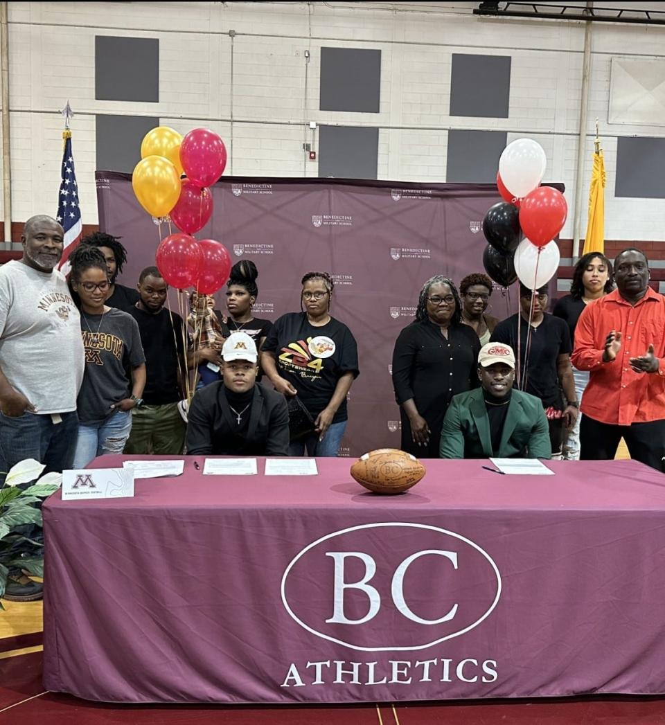 Benedictine's Za'Quan Bryan (left at table) signed with Minnesota and Lamont Mitchell signed with Georgia Military College Wednesday.