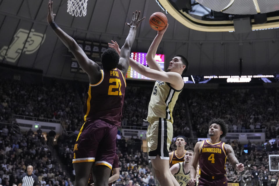 Purdue center Zach Edey (15) shoots over Minnesota forward Pharrel Payne (21) during the second half of an NCAA college basketball game in West Lafayette, Ind., Thursday, Feb. 15, 2024. (AP Photo/Michael Conroy)