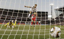 FILE - In this June 27, 2010 file photo Germany's Thomas Mueller, center, celebrates scoring his side's forth goal past England goalkeeper David James, left, during the World Cup round of 16 soccer match between Germany and England at Free State Stadium in Bloemfontein, South Africa. (AP Photo/Gero Breloer, File)