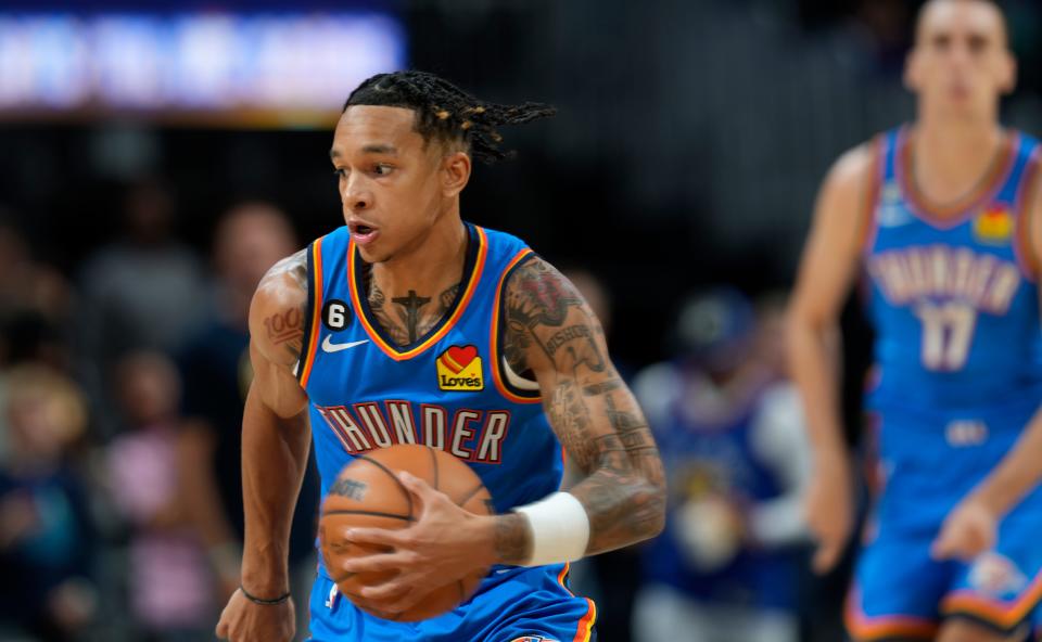 OKC Thunder guard Tre Mann scoops up the ball in the first half of an NBA preseason basketball game against the Denver Nuggets on Monday.