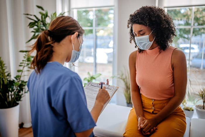 A doctor taking down a patient's information