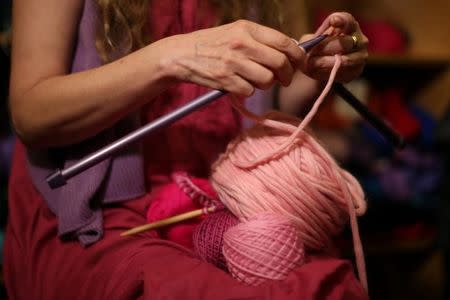 A knitter takes part in the Pussyhat social media campaign to provide pink hats for protesters in the women's march in Washington, D.C., the day after the presidential inauguration, in Los Angeles, California, U.S., January 13, 2017. REUTERS/Lucy Nicholson