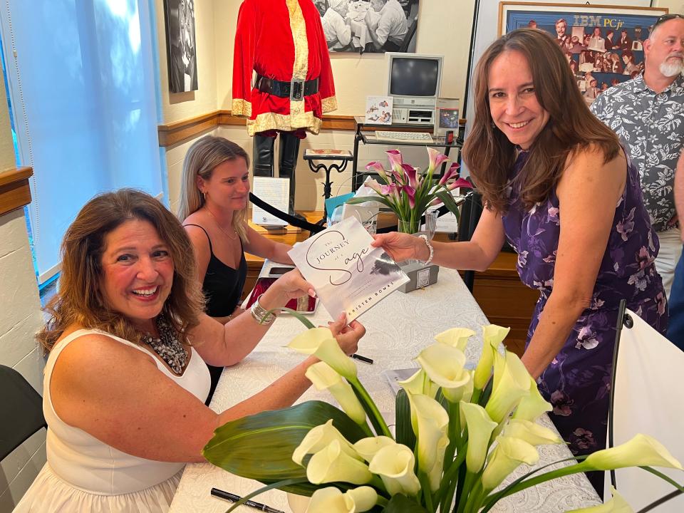 At a book signing in Boca Raton last month, psychologist Kristen Bomas (left) signed a copy of The Journey of a Sage for Valentina Moretti.