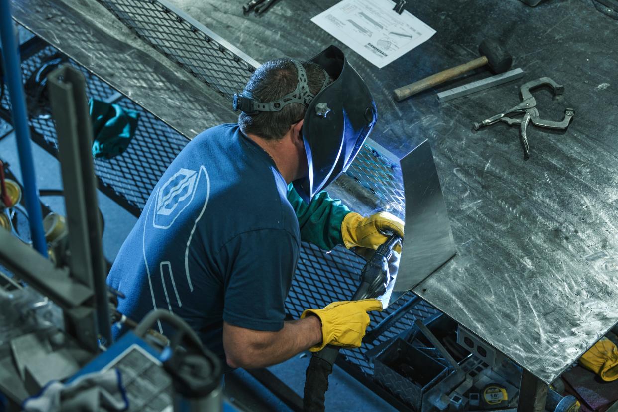 A worker using tools at DiamondBack Covers