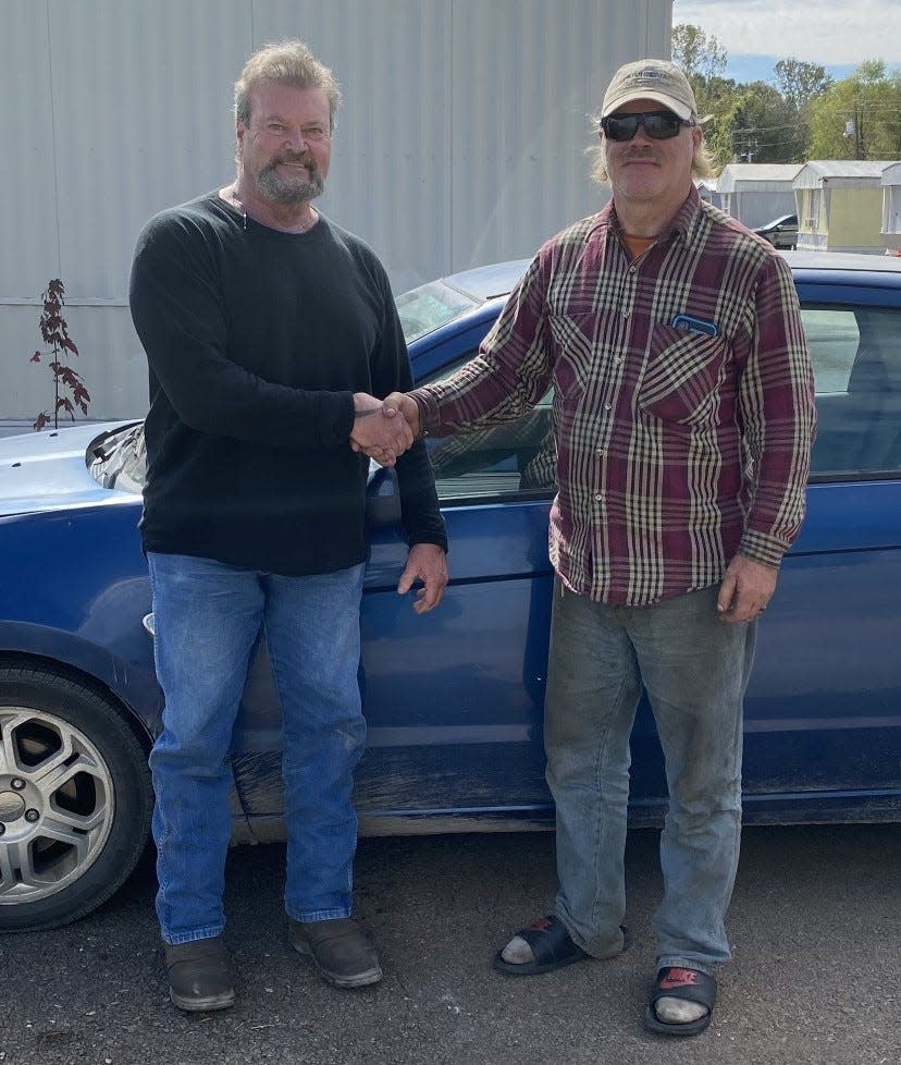 Alabama resident Ronnie Dugger (left) shakes hands with Ernest Chandler. Dugger and his wife gave Chandler a car after finding out the man was walking two hours to work and two hours back because he had no vehicle.