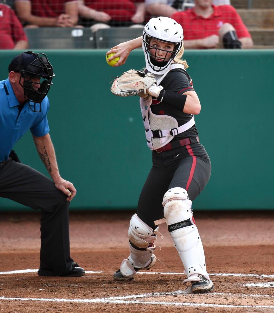 Alabama catcher Ally Shipman makes a snap throw to first in an attempt to catch at Texas base runner off the bag in Rhoads Stadium Saturday, March 5, 2022, in the Crimson Classic. 