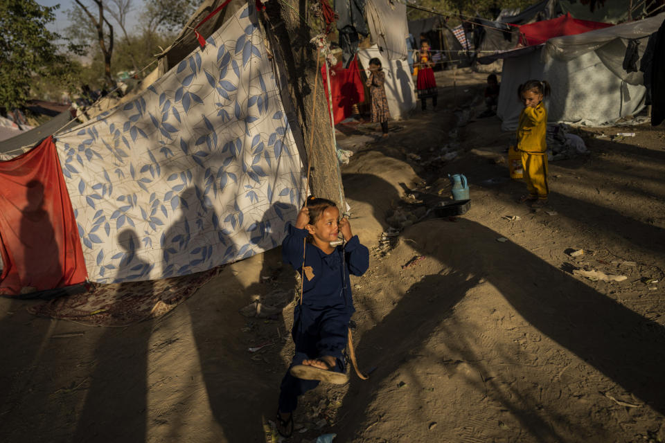 A displaced Afghan child plays at a camp for internally displaced persons in Kabul, Afghanistan, Monday, Sept. 13, 2021. (AP Photo/Bernat Armangue)