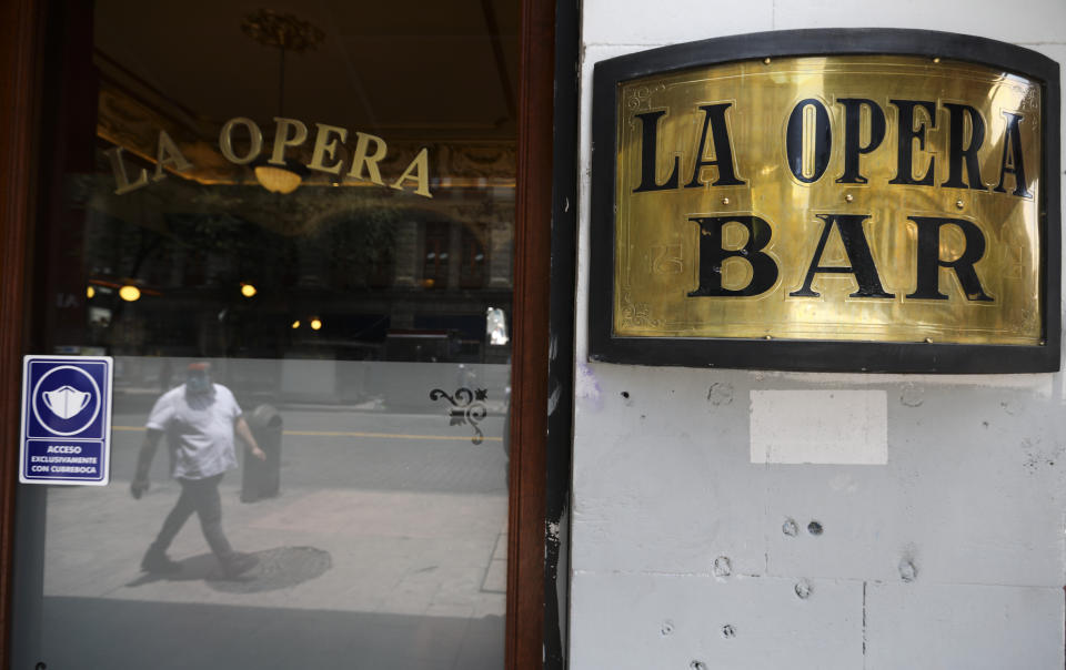 COVID-19 prevention signs are displayed on the windows of a restaurant in Mexico City, Wednesday, July 1, 2020. (AP Photo/Eduardo Verdugo)