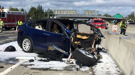 Rescue workers attend the scene where a Tesla electric SUV crashed into a barrier on U.S. Highway 101 in Mountain View, California, March 25, 2018. KTVU FOX 2/via REUTERS/Files
