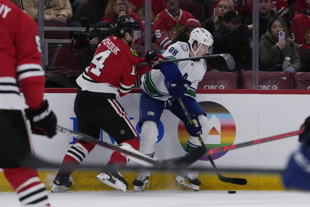Vancouver Canucks center Nils Aman, right, looks to pass against Chicago Blackhawks left wing Boris Katchouk during the first period of an NHL hockey game in Chicago, Sunday, March 26, 2023. (AP Photo/Nam Y. Huh)