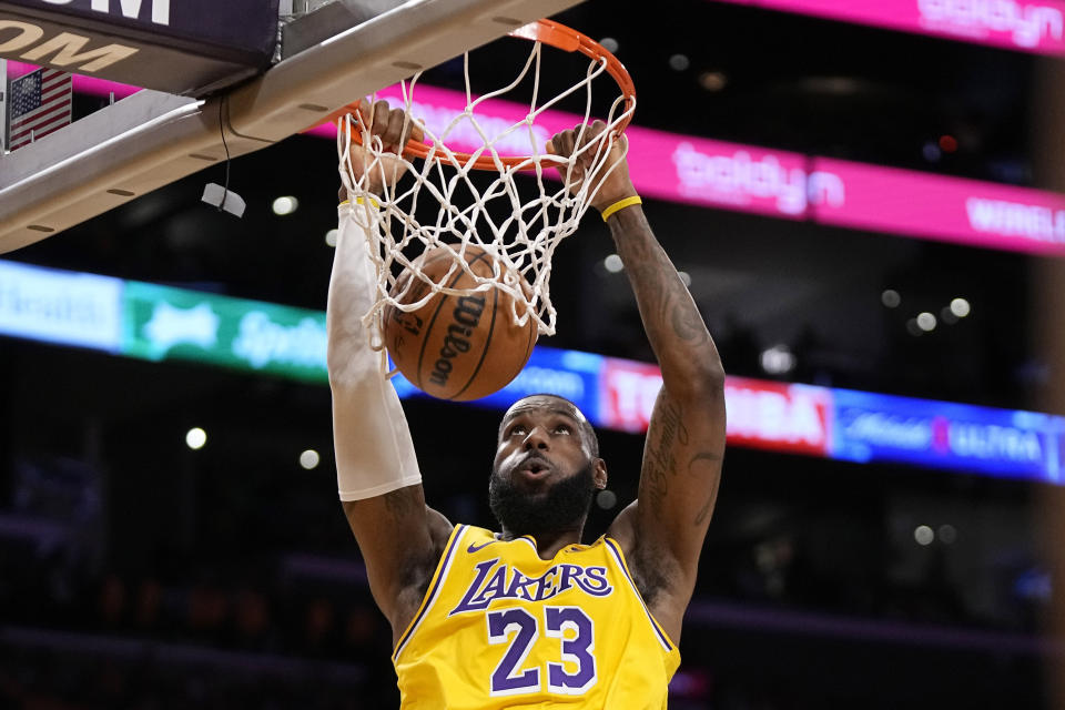 Los Angeles Lakers forward LeBron James dunks during the first half of an NBA basketball game against the Phoenix Suns Thursday, Oct. 26, 2023, in Los Angeles. (AP Photo/Mark J. Terrill)