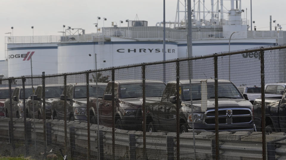 New vehicles are shown parked in storage lots near the the Stellantis Detroit Assembly Complex in Detroit, Wednesday, Oct. 5, 2022. Over the past few years, thieves have driven new vehicles from automaker storage lots and dealerships across the Detroit area. In 2018, eight vehicles were driven from what then was Fiat Chrysler's Jefferson North plant. (AP Photo/Paul Sancya)