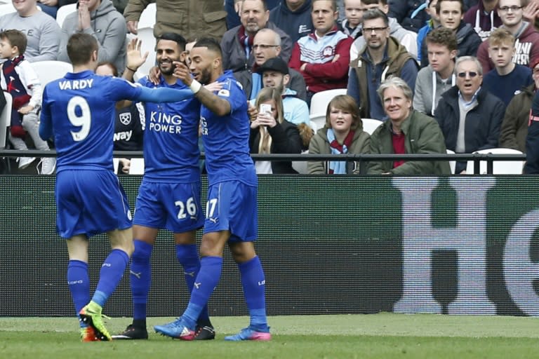 Leicester City's midfielder Riyad Mahrez (C) celebrates with striker Jamie Vardy (L) and defender Danny Simpson after scoring during the English Premier League football match against West Ham United March 18, 2017