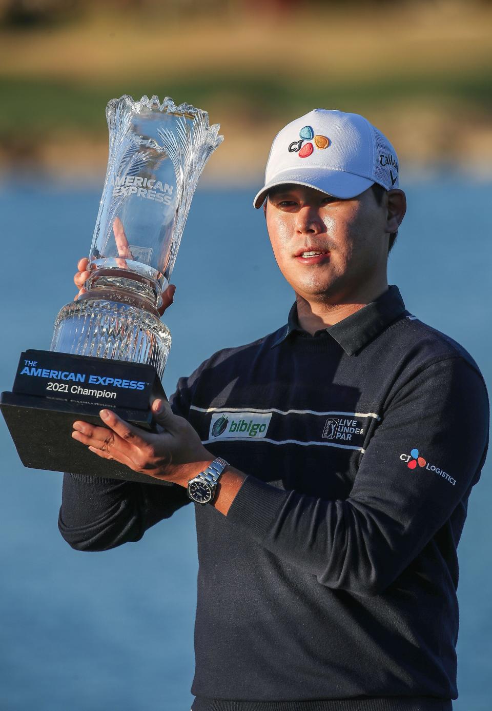 Si Woo Kim holds the trophy after winning the American Express at PGA West in La Quinta, January 24, 2021. 