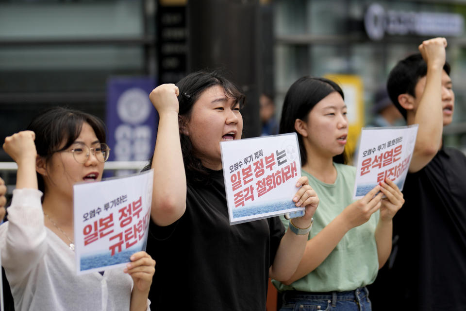 Students shout slogans during a rally to oppose the Japanese government's plan to release treated radioactive water into the sea from the Fukushima nuclear power plant, in Seoul, South Korea, Friday, July 7, 2023. The letters read, "Denounce Japanese government." (AP Photo/Lee Jin-man)