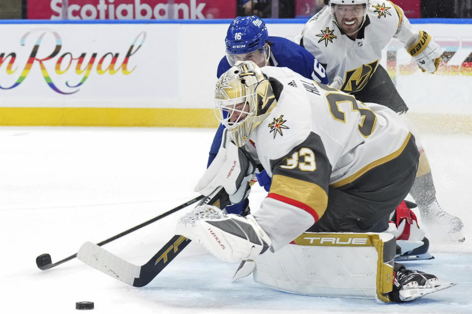 Vegas Golden Knights goaltender Adin Hill (33) saves a shot from Toronto Maple Leafs' Mitchell Marner during the second period of an NHL hockey game in Toronto, on Tuesday, Feb. 27, 2024. (Chris Young/The Canadian Press via AP)