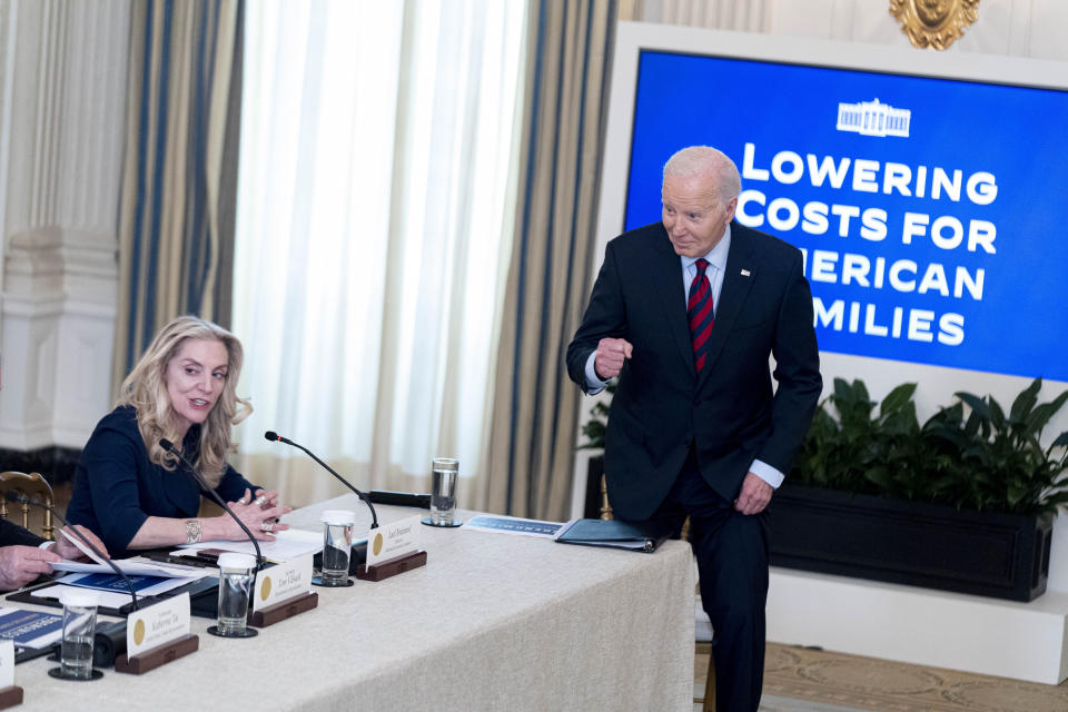 President Joe Biden, accompanied Lael Brainard, director of the National Economic Council, left, pumps his fist as he joins a meeting of his Competition Council in the State Dining Room of the White House in Washington, Tuesday, March 5, 2024. (AP Photo/Andrew Harnik)