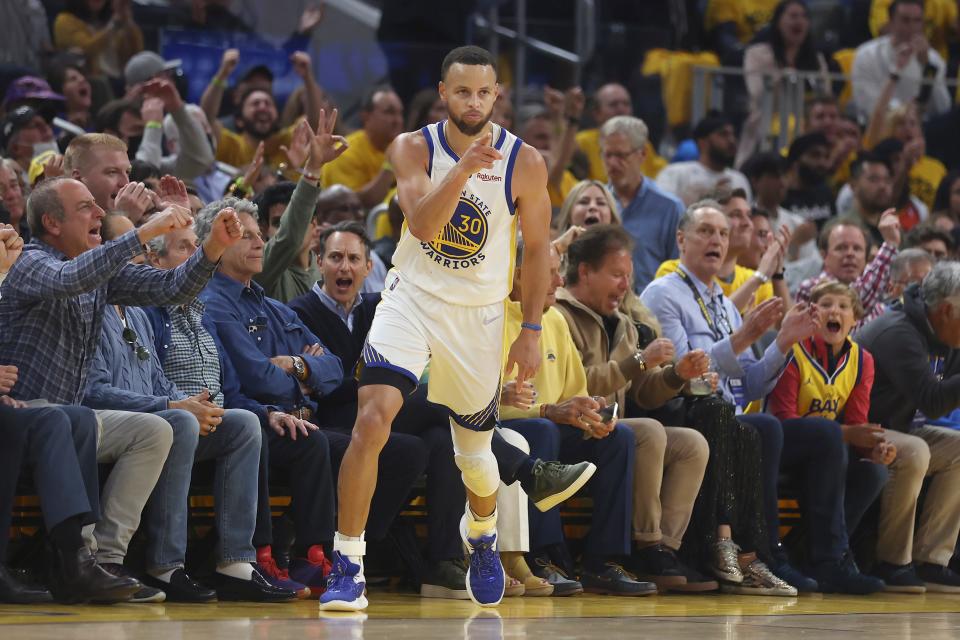 Golden State Warriors guard Stephen Curry reacts after scoring against the Dallas Mavericks during the first half of Game 2 of the NBA basketball playoffs Western Conference finals in San Francisco, Friday, May 20, 2022. (AP Photo/Jed Jacobsohn)