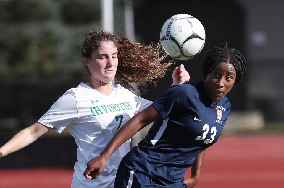From left, Irvington's Amanda Raimondo (7) and Briarcliff's Sora Marable (33)  battle for ball control during girls soccer playoff action at Briarcliff High School Oct. 28, 2021. Briarcliff won the game 1-0.