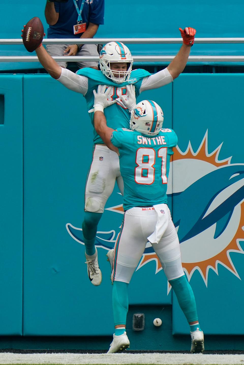 Miami Dolphins tight end Durham Smythe (81) lifts tight end Mike Gesicki (88) after Gesicki scored a touchdown, during the second half of an NFL football game against the Cincinnati Bengals, Sunday, Dec. 6, 2020, in Miami Gardens, Fla. (AP Photo/Lynne Sladky)