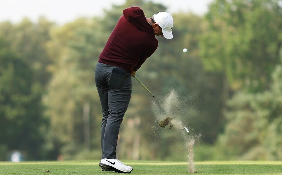 Rory McIlroy plays his second shot on the 12th hole as his club head breaks during day one of the BMW PGA Championship at Wentworth