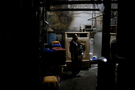 Yu Nanxian, 66, the owner of Hans Men's Sauna, stands in the laundry room of his sauna in Taipei, Taiwan, November 14, 2018.REUTERS/Ann Wang