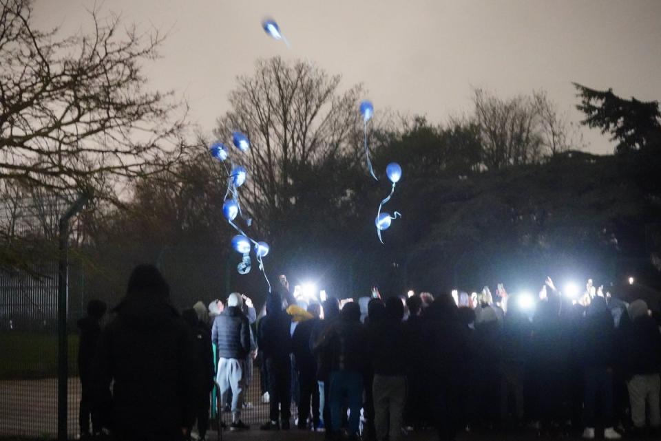 Around a hundred people – including Harry’s mother, brother, and sister – gathered at Downhills Park to pay their respect at a vigil for the “bright and promising” teenager, with many carrying flowers and balloons (PA)