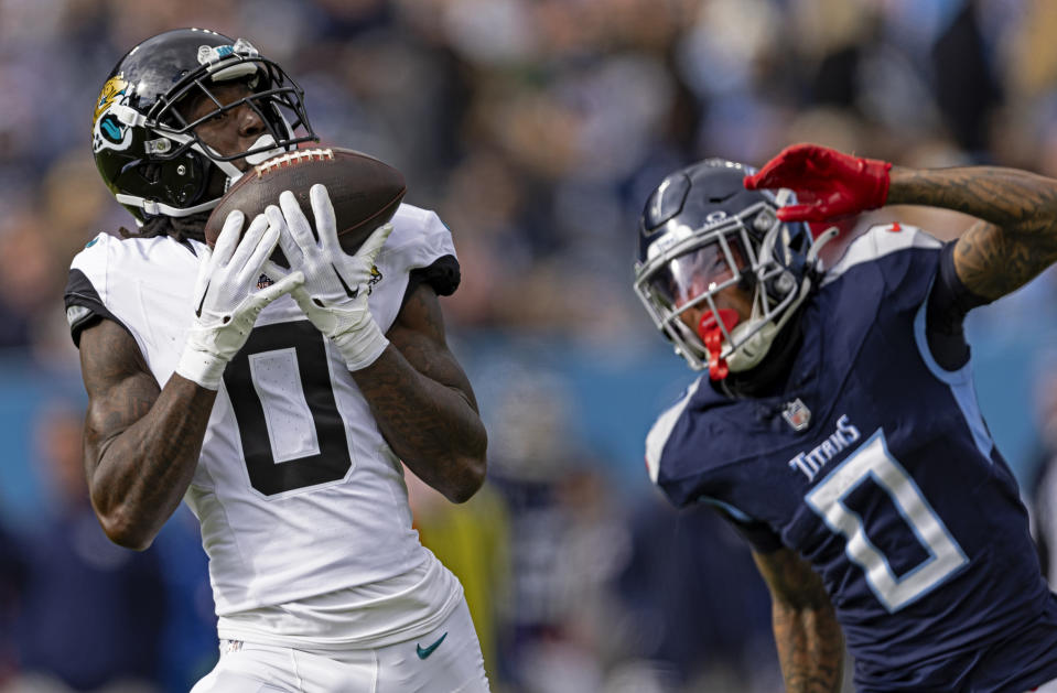 FILE - Jacksonville Jaguars wide receiver Calvin Ridley (0) catches a pass in front of Tennessee Titans cornerback Sean Murphy-Bunting (0) during their NFL football game Sunday, Jan. 7, 2024, in Nashville, Tenn. Ridley and the Tennessee Titans have agreed on a four-year, $92 million contract, a person with knowledge of the terms told The Associated Press on Wednesday, March 13, 2024. (AP Photo/Wade Payne, File)