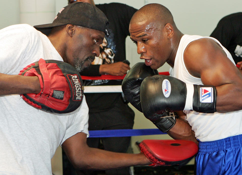 Boxer Floyd Mayweather Jr. (R) works out with his trainer and uncle Roger Mayweather at the Mayweather Boxing Club May 1, 2007 in Las Vegas, Nevada. Mayweather Jr. will fight Oscar De La Hoya for the WBC super welterweight championship at the MGM Grand on May 5, 2007.  (Photo by Ethan Miller/Getty Images)