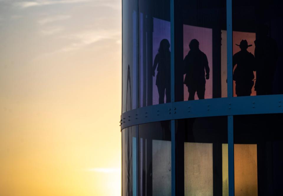 Festivalgoers walk up "Spectra" by NEWSUBSTANCE during the Coachella Valley Music and Arts Festival in Indio, Calif., Friday, April 19, 2024.