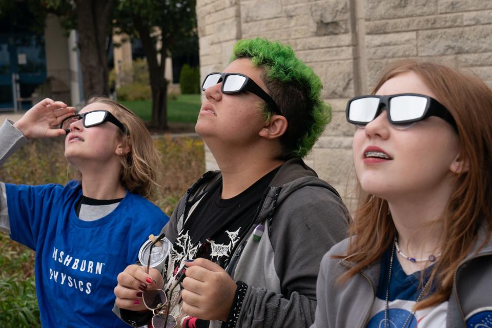 Area organizations are hosting watch parties for the April 8 solar eclipse. Several months ago, middle school students, from left, Natalia Cronberg, Teddy Hildenbrand and Izzy Greig, wore their safety glasses hoping for a break in the clouds to view the annular solar eclipse at Washburn University.