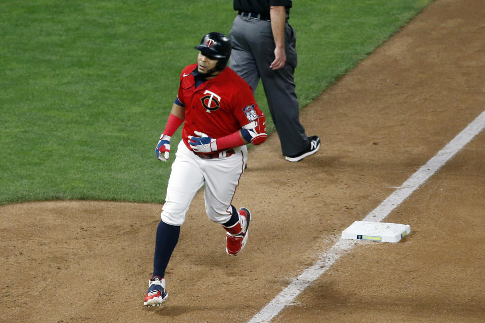 Minnesota Twins designated hitter Nelson Cruz rounds third base after hitting a two-run home run off Milwaukee Brewers' pitcher Freddy Peralta in the seventh inning of a baseball game Thursday, Aug. 20, 2020, in Minneapolis. (AP Photo/Jim Mone)