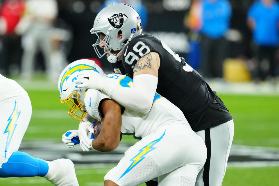Dec 14, 2023; Paradise, Nevada, USA; Las Vegas Raiders defensive end Maxx Crosby (98) tackles Los Angeles Chargers running back <a class="link " href="https://sports.yahoo.com/nfl/players/30423" data-i13n="sec:content-canvas;subsec:anchor_text;elm:context_link" data-ylk="slk:Austin Ekeler;sec:content-canvas;subsec:anchor_text;elm:context_link;itc:0">Austin Ekeler</a> (30) in the first quarter at Allegiant Stadium. Mandatory Credit: Stephen R. Sylvanie-USA TODAY Sports