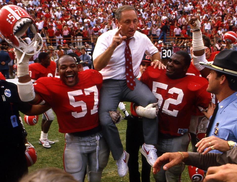 11/9/85 - DENNIS HAMILTON JR./The Times-Union - University of Georgia head coach Vince Dooley is carried off the field by some of his Bulldogs after Georgia beat the University of Florida Gators 24-3 in the Gator Bowl in November 1985.