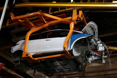 A partially assembled 2018 Chevrolet Bolt EV vehicle moves down the assembly line at General Motors Orion Assembly in Lake Orion, Michigan, U.S., March 19, 2018. REUTERS/Rebecca Cook/Files