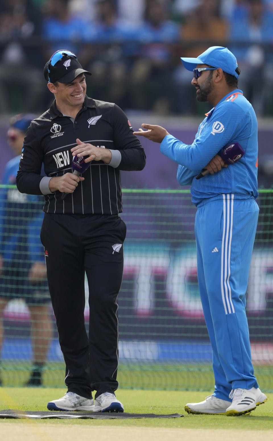 New Zealand's captain Tom Latham, left, and India's captain Rohit Sharma interact before the toss ahead of the ICC Men's Cricket World Cup match between India and New Zealand in Dharamshala, India, Sunday, Oct. 22, 2023. (AP Photo/Manish Swarup)