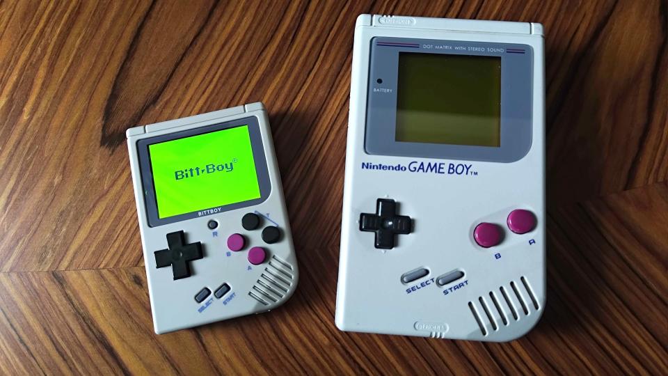 Bittboy next to original Gameboy on woodgrain table