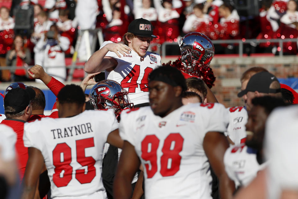 Western Kentucky placekicker Cory Munson, top center, is carried around the field on the shoulders of teammates after kicking the winning field goal in the First Responder Bowl NCAA college football game against Western Michigan in Dallas, Monday, Dec. 30, 2019. (AP Photo/Roger Steinman)