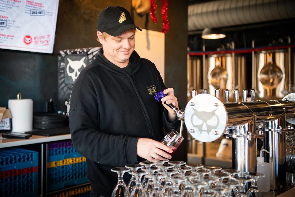 Bentley Blackshear, co-owner and director of brewing operations at Xul Beer Company, pours a glass of the brewery's wildly popular PB&J Mixtape sour containing real roasted peanuts and a "pretty outrageous amount of grape concentrate." While the brewery tries to keep the beer on at both the downtown and Hardin Valley taprooms, cans are harder to come by.