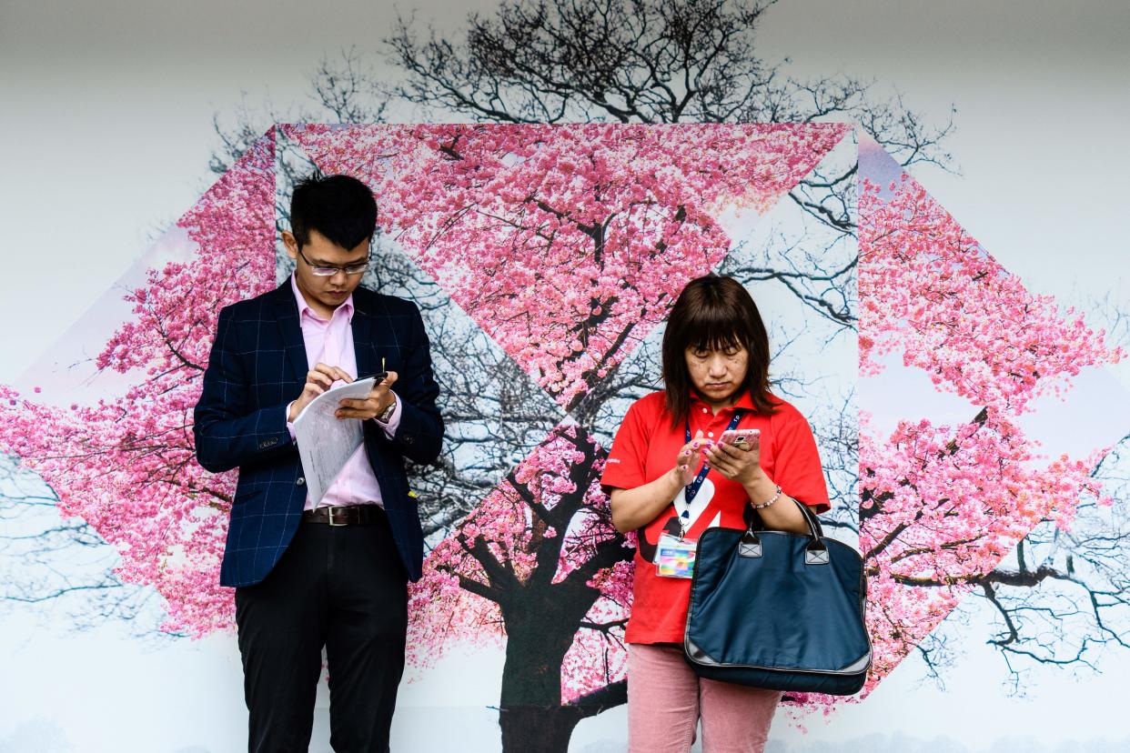 Commuters stand in front of a billboard advertisement for HSBC bank in Hong Kong on February 20, 2018. Photo: ANTHONY WALLACE/AFP/Getty Images