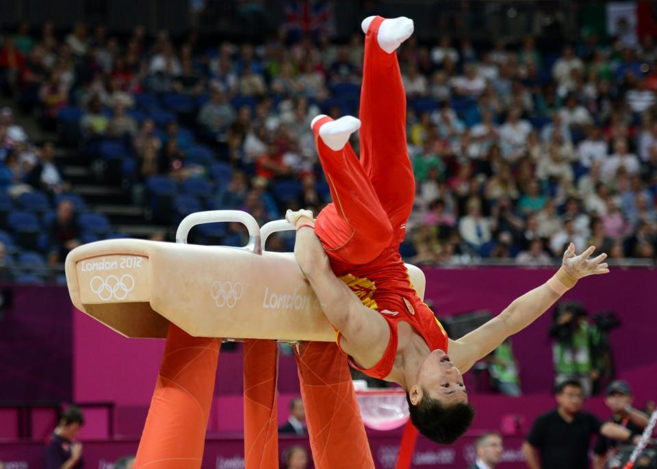 China's Chenglong Zhang falls from the pommel horse during the Artistic Gymnastics team qualification at the North Greenwich Arena, London, on day one of the London 2012 Olympics.. Picture date: Saturday July 28, 2012. Photo credit should read: Anthony Devlin/PA Wire. Editorial Use Only