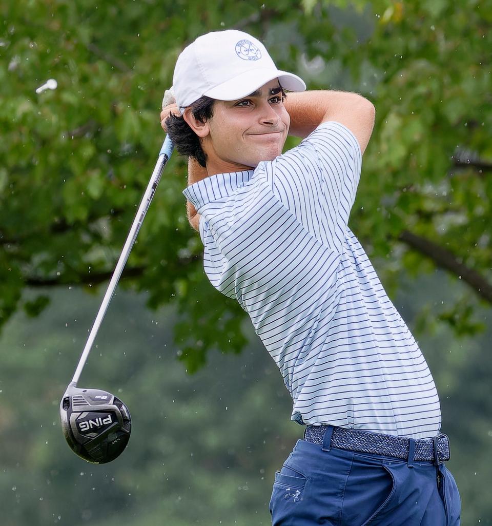 Hudson's Sam Fauver tees off at the 24-team Hudson Invitational Monday afternoon at the rain-soaked Country Club of Hudson