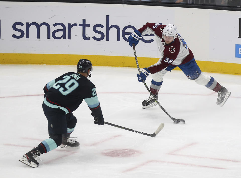 Colorado Avalanche left wing Anton Blidh (36) shoots against Seattle Kraken defenseman Vince Dunn (29) during the first period of an NHL hockey game Saturday, Jan. 21, 2023, in Seattle. (AP Photo/Lindsey Wasson)