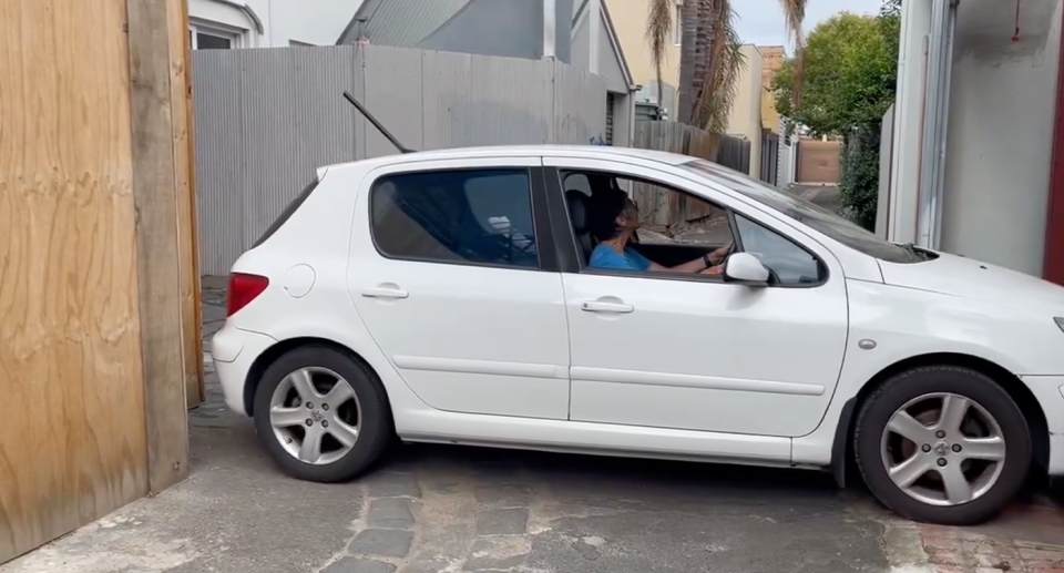 Melbourne woman Janette Fly trying to move her car. 