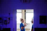 Chief coral scientist Keri O'Neill speaks with lab personnel near an aquarium full of Pillar coral (Dendrogyra cylindricus) just a few days before the animals would successfully spawn in an aquarium for the first time at a Florida Aquarium facility in Apol